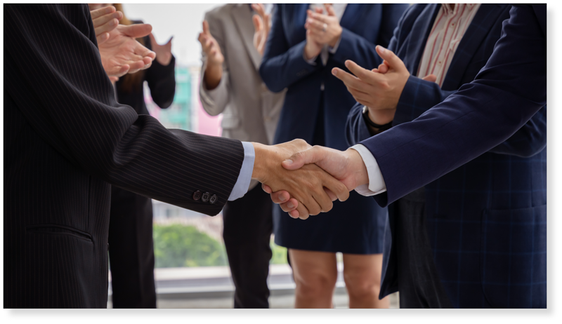 Two men in suits shaking hands